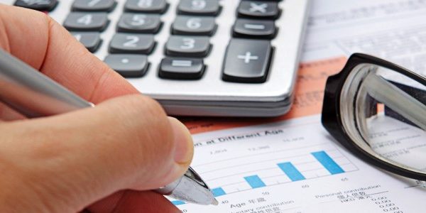 Stock chart with calculator,pen and eyeglasses