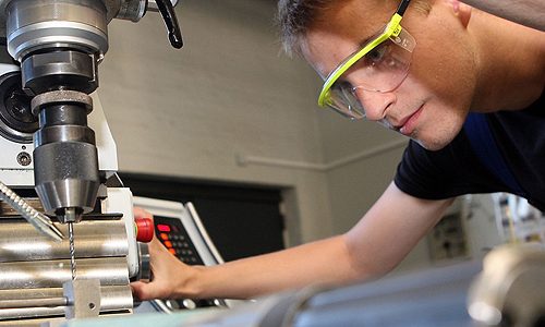 BERLIN, GERMANY - SEPTEMBER 03:  A trainee uses a milling machine at a Siemens training center on September 3, 2012 in Berlin, Germany. Nearly 400 trainees began their apprenticeship training programs today at an in-house educational facility at the Siemens factory in Berlin.  (Photo by Adam Berry/Getty Images)