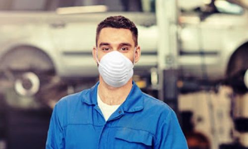 car service, repair, maintenance and people concept - happy smiling auto mechanic man or smith with clipboard at workshop